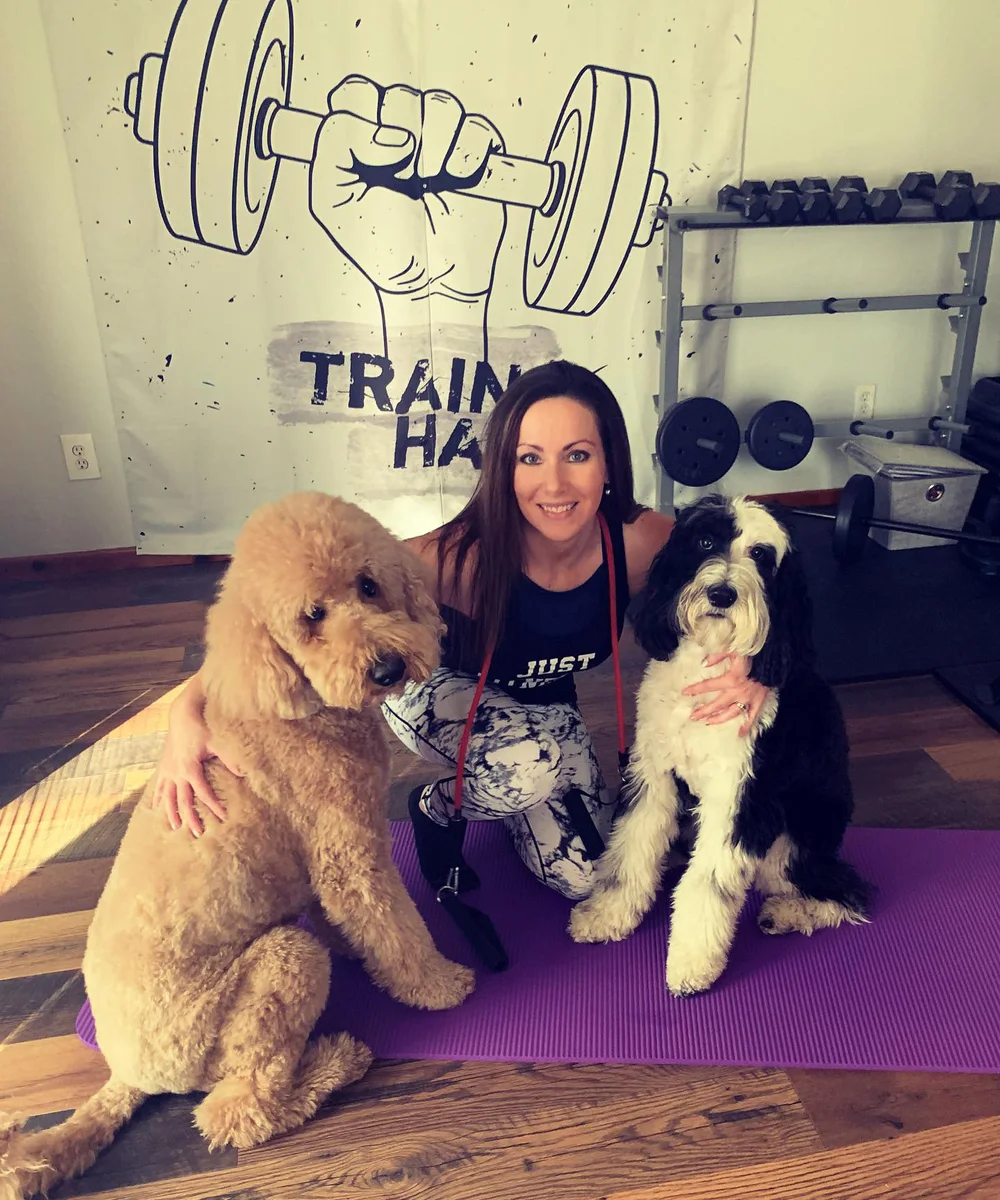 Autumn Nelson in her training studio with her two dogs